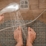 Someone showering while standing on an anti-slip mat